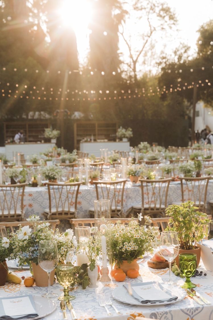 Styled shoot inspiration of beautiful outdoor wedding table setup and decor with string lights.