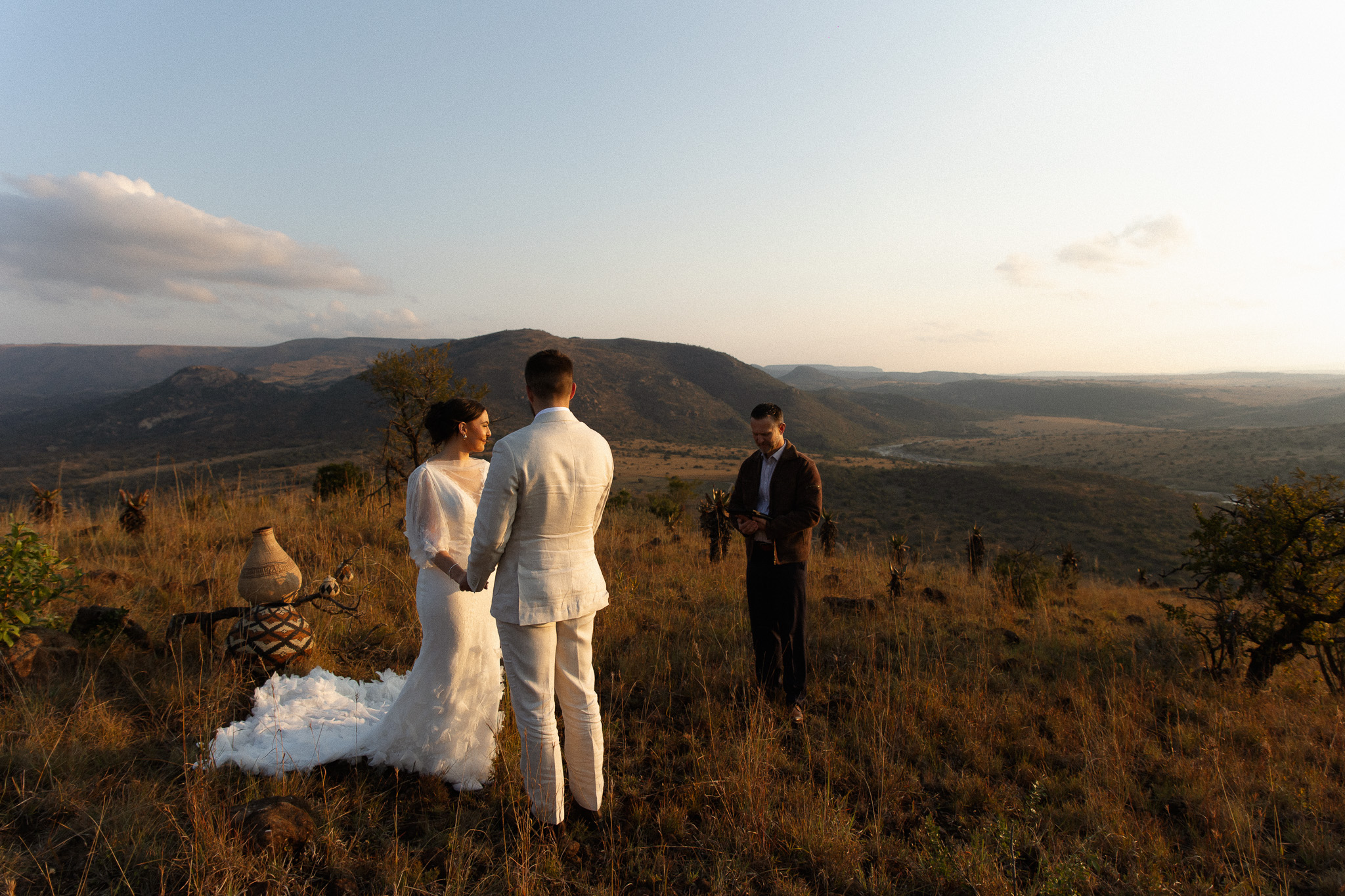 International couple exchanging vows during a South Africa elopement overlooking the bush