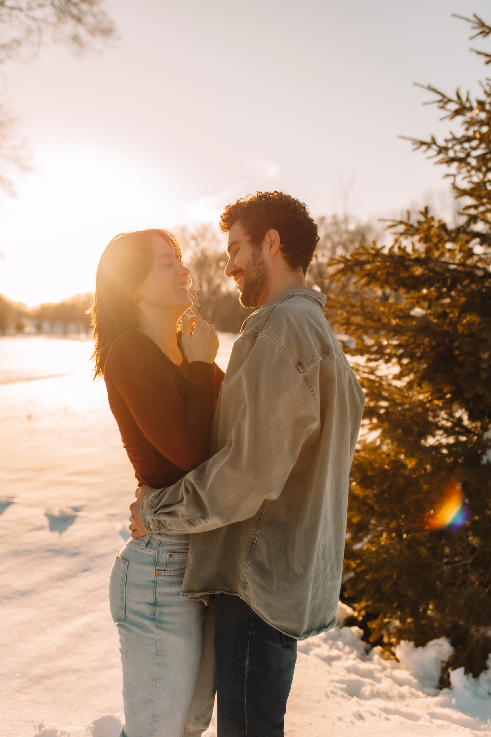 Engagement photos of couple in the snow during sunset at Lake Nokomis in Minneapolis