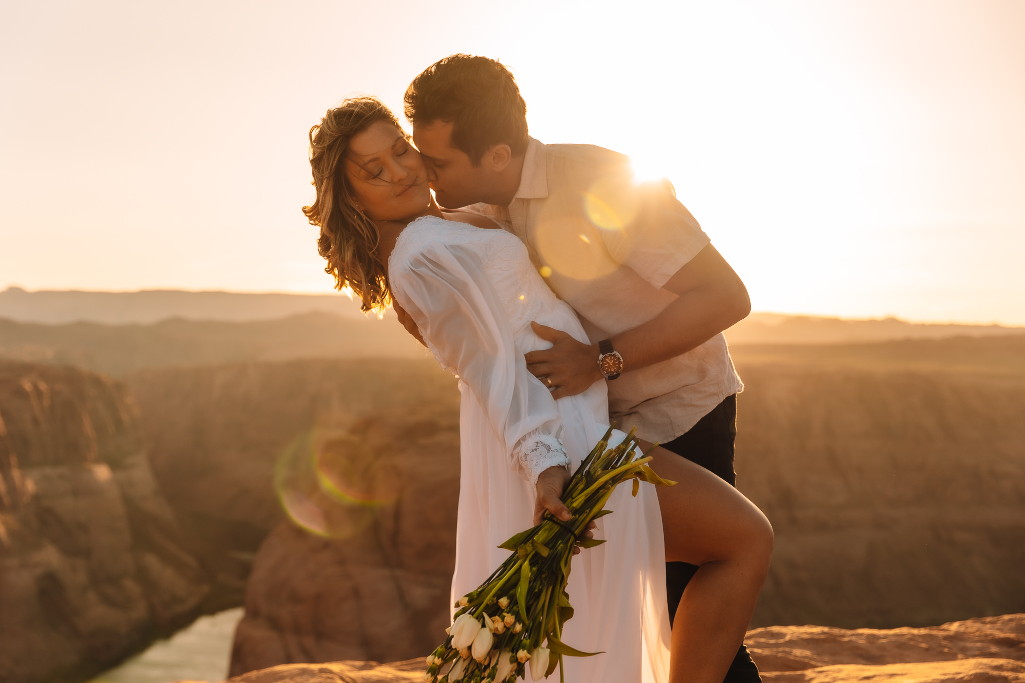 Horseshoe Bend elopement couple in Page, Arizona in front of the canyon during sunset
