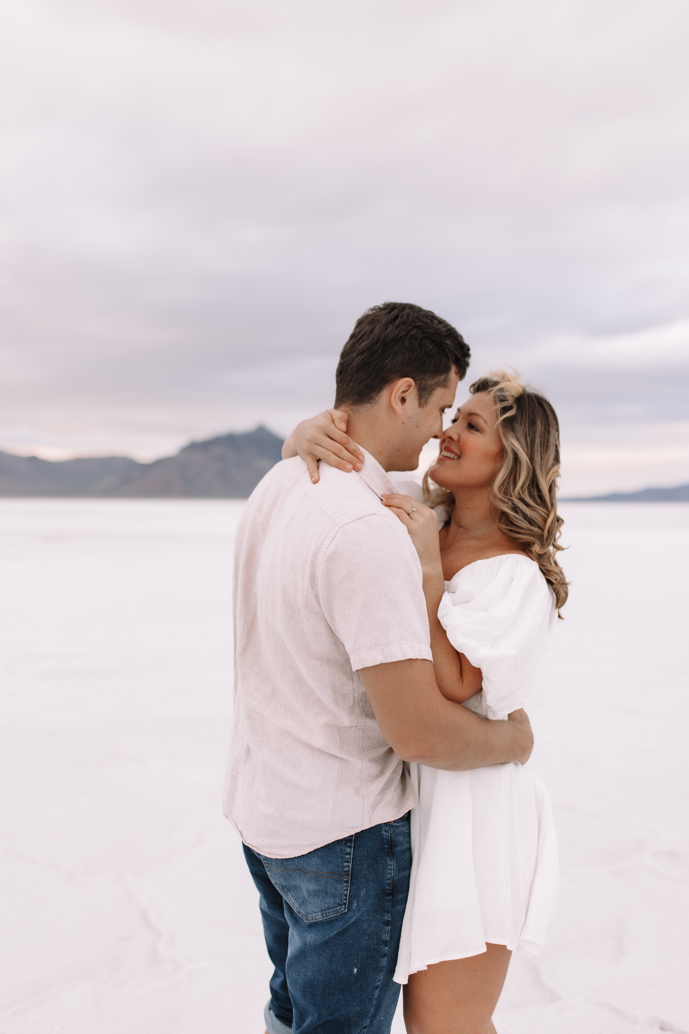 Elopement couple holding each other close, noses touching, at the Salt Flats in Utah