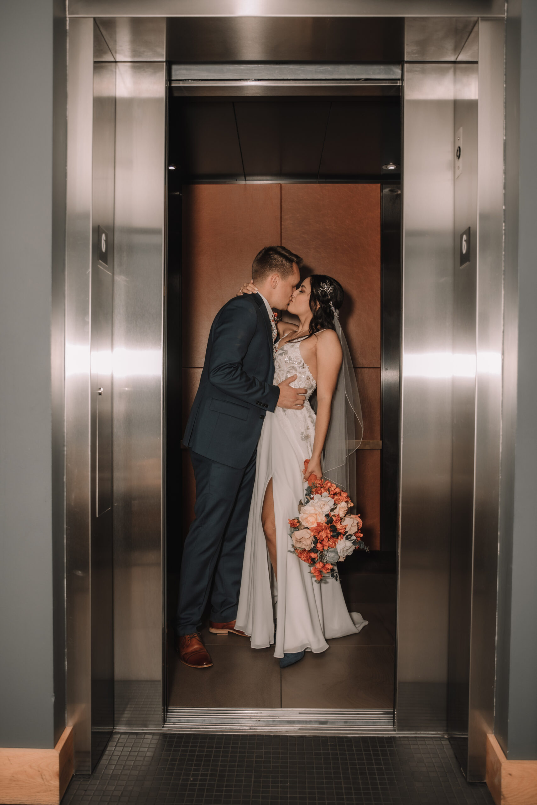 Steamy elevator photo of bride and groom making out in the Hewing Hotel in Downtown Minneapolis