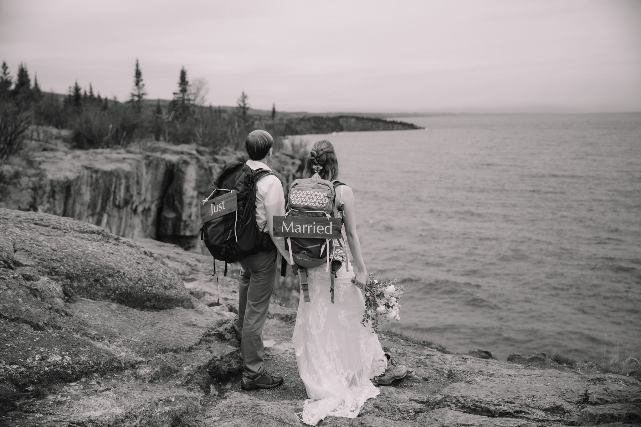Hiking elopement couple standing on the edge of Palisade head in Minnesota on the North Shore