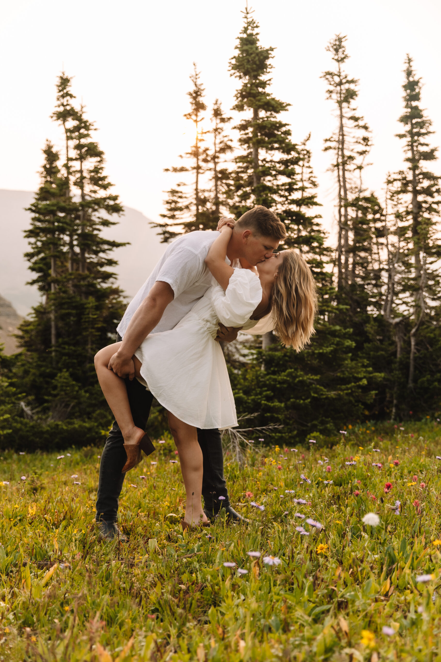 Groom dip kissing his bride in Glacier National Park 