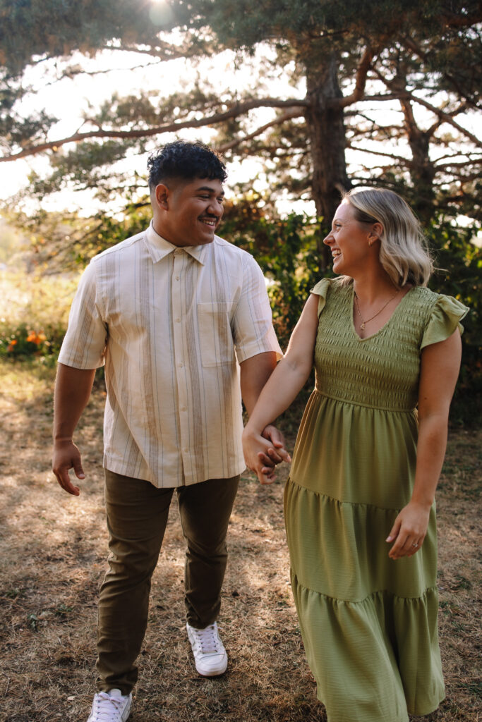 Engagement couple walking side by side during sunset at Boom Island Park in- One of the best engagement photo locations in Minneapolis