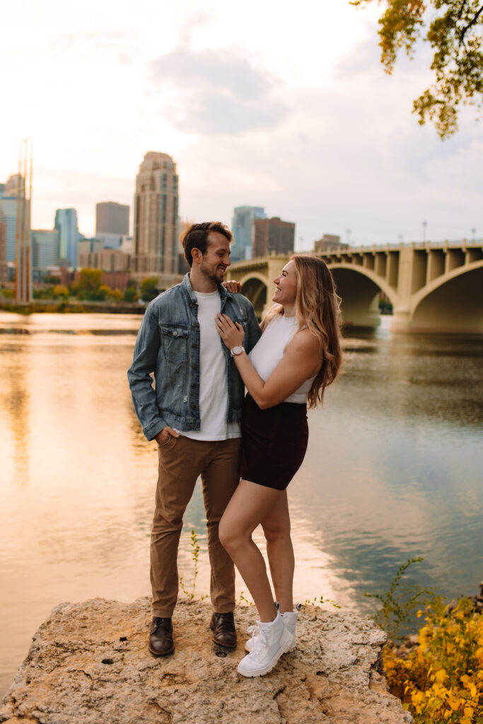 Engagement Couple at Nicollet Island in Minneapolis, Minnesota with the Minneapolis skyline in the background