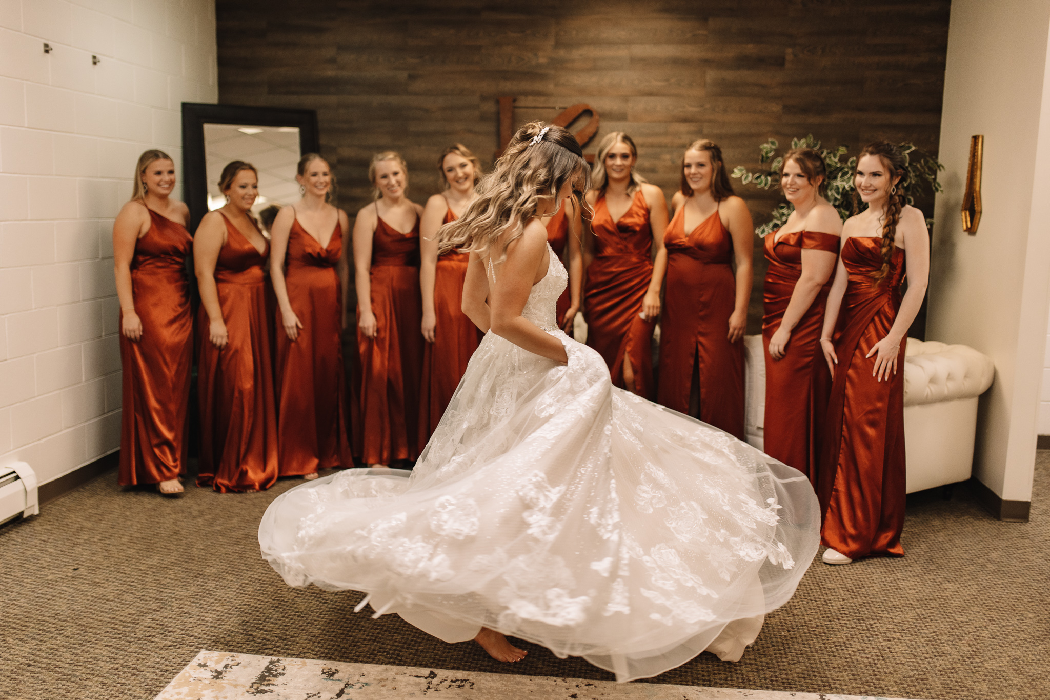 Wedding in Stillwater at the Oak Glen Golf Club. Bride revealing her dress to bridesmaids