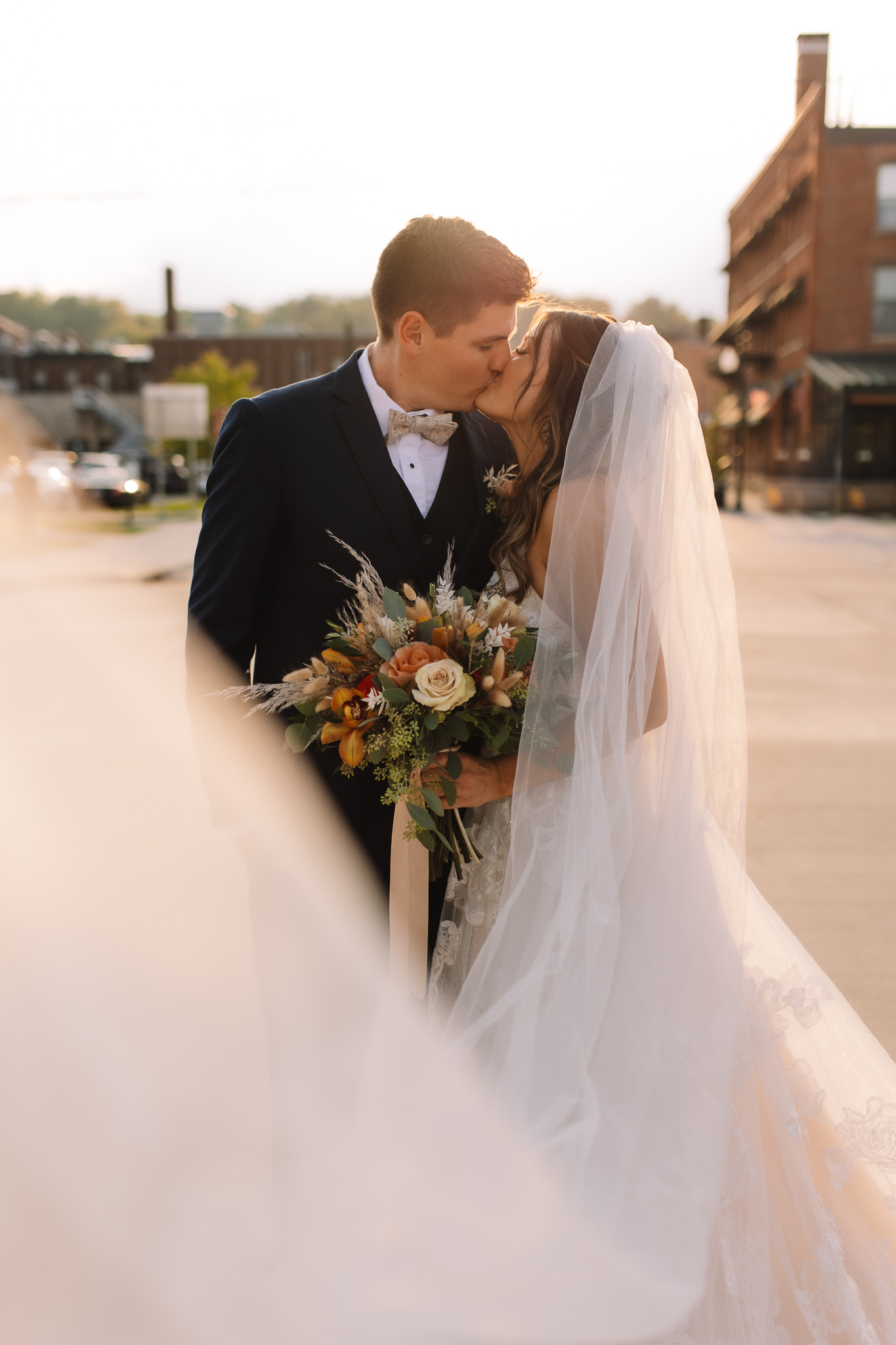 Bride and Groom Portraits in Stillwater in front of the Iconic bridge crossing the St. Croix river