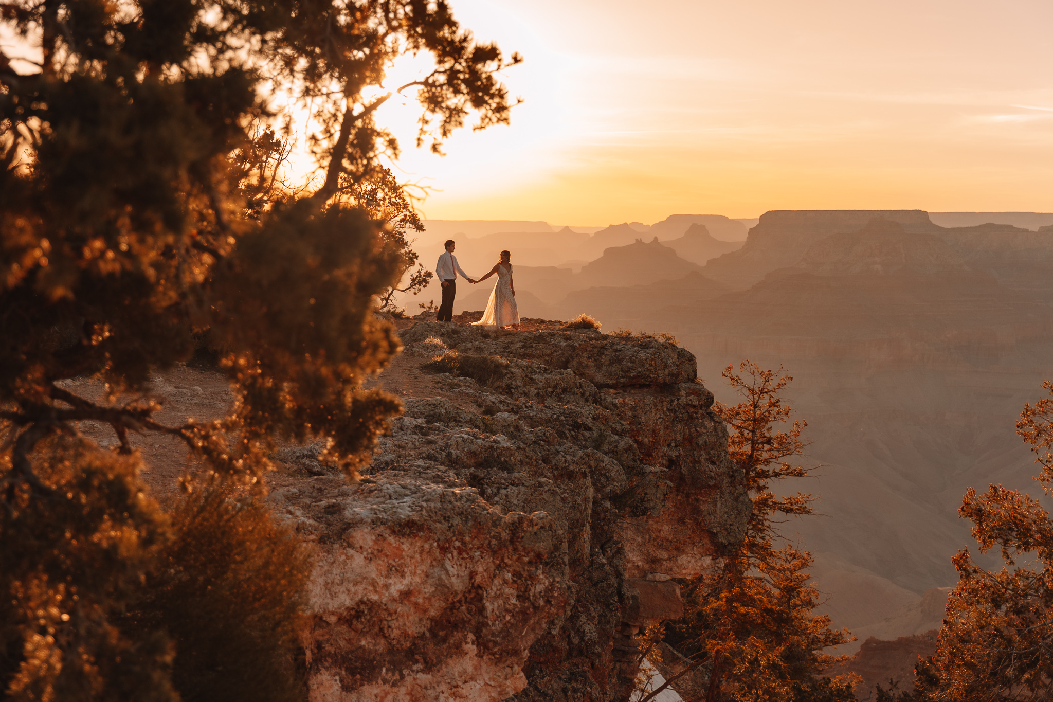 Elopement couple hiking in wedding dress and suite at the Grand Canyon in Arizona