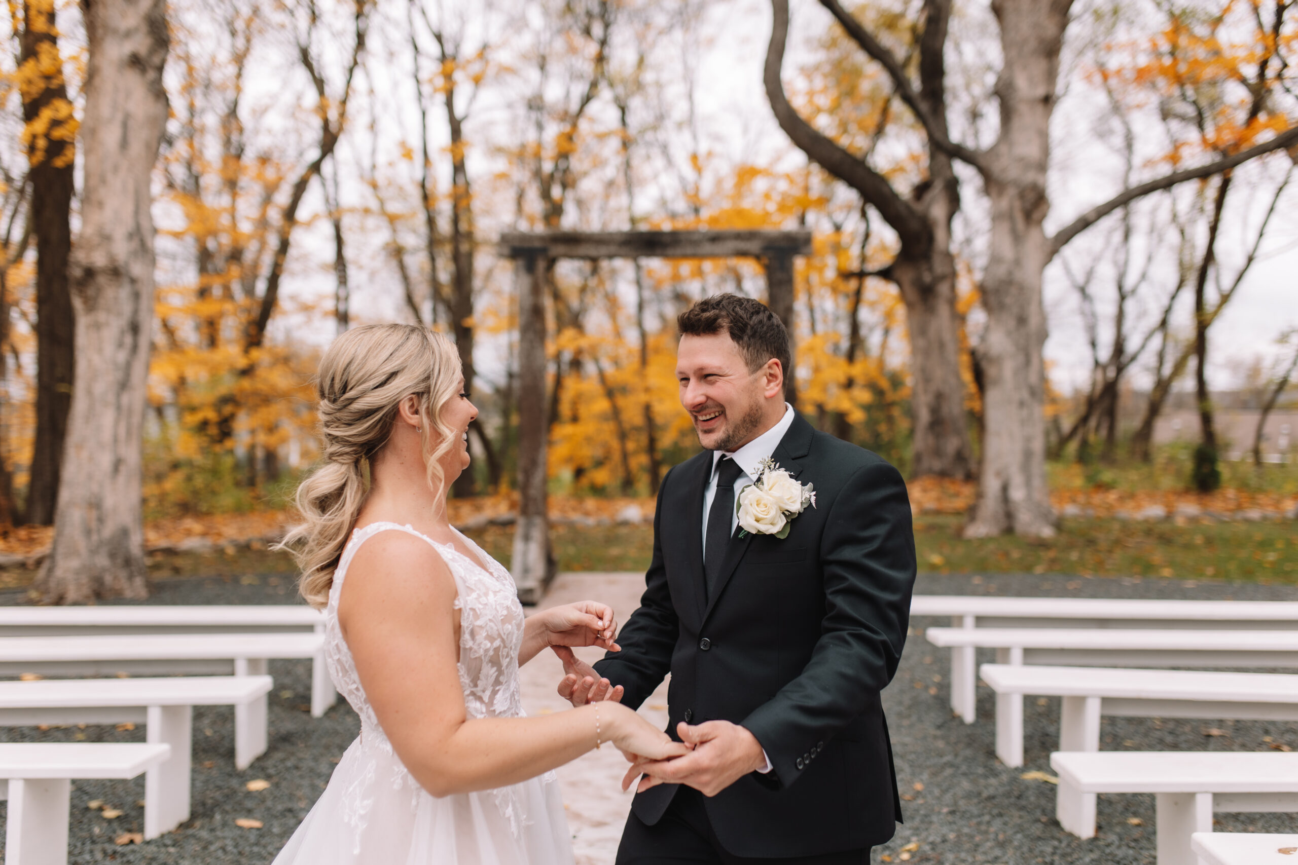 Groom taking his Bride's hands as he smiles at her happily during their first look