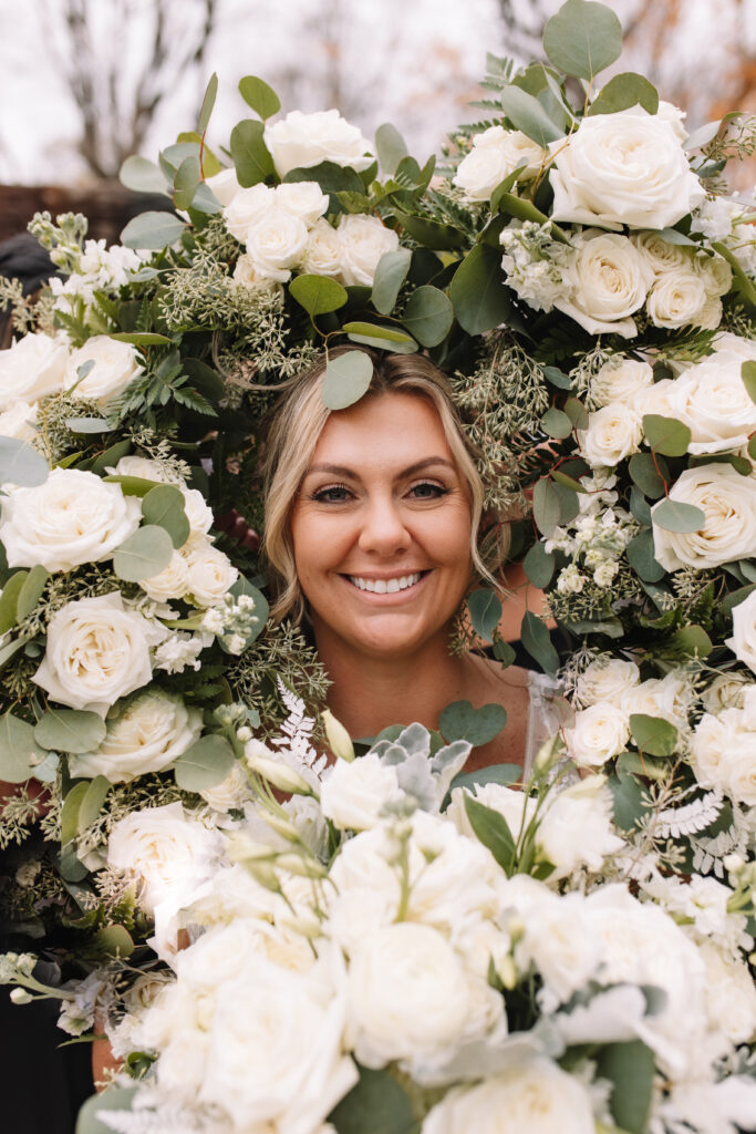 Beautiful green and white wedding bouquets surrounding bride's face