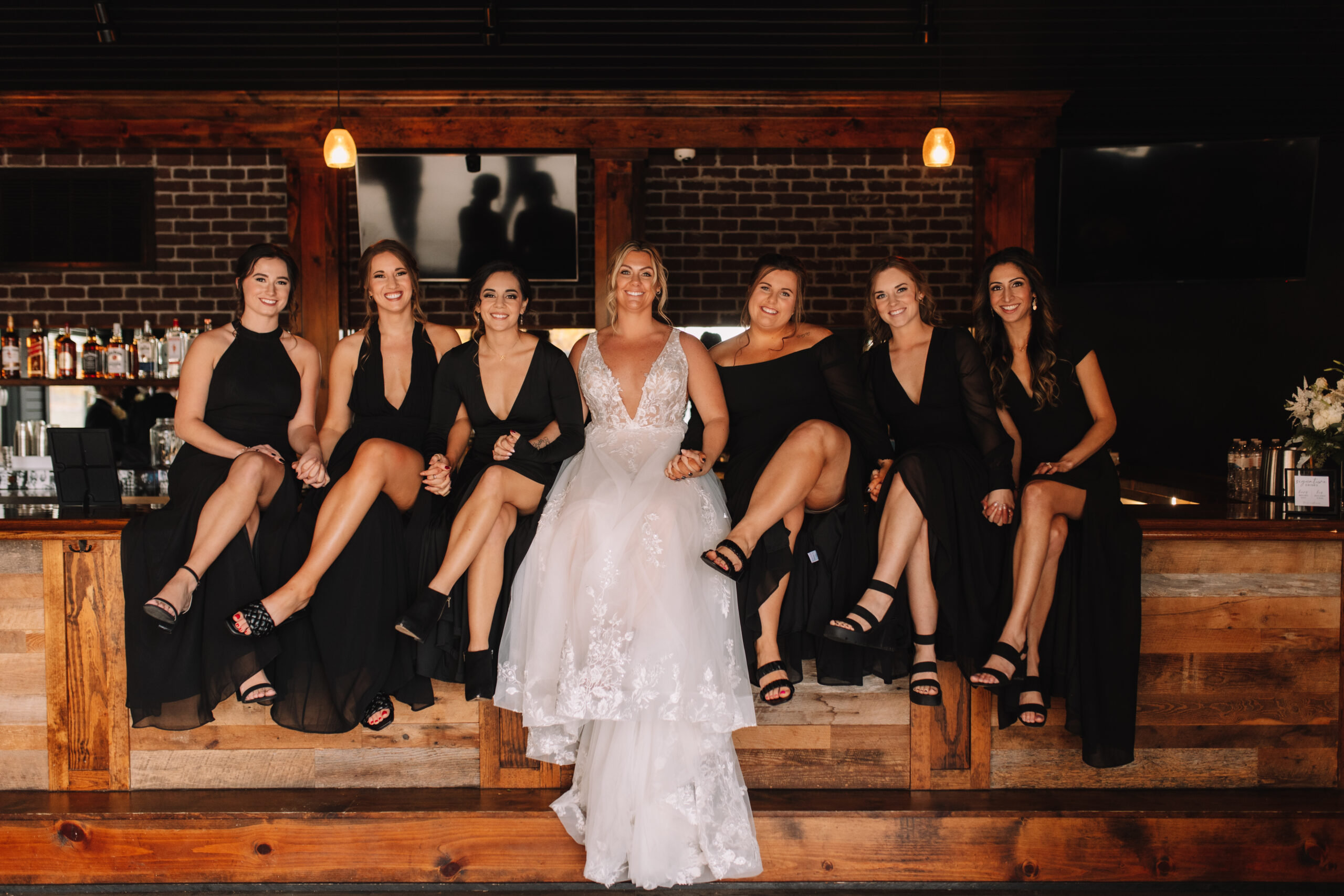 Bridal Party Sitting at the bar at the Ahavah Cottage Wedding Venue
