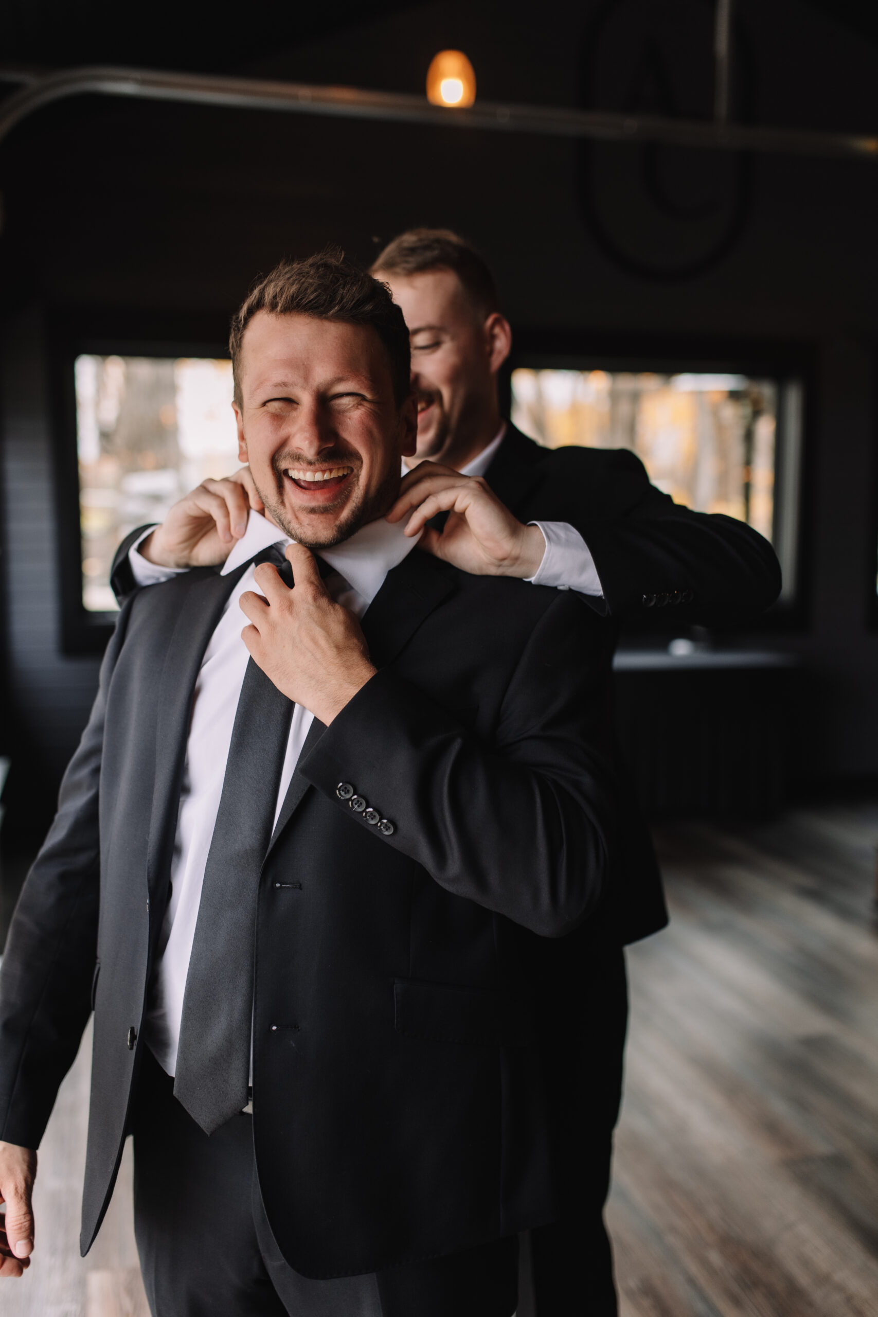 Groom getting ready with best man at Ahavah Cottage Wedding venue in Minnesota