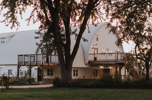 Stunning white barn style wedding venue in Minnesota called the Historic Fuber Farm