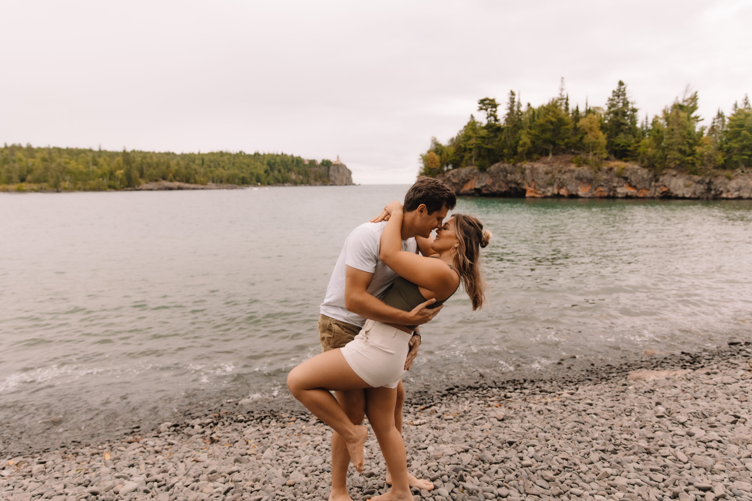 Engagement couple dip kissing at Split Rock Lighthouse on the North Shore in Minnesota