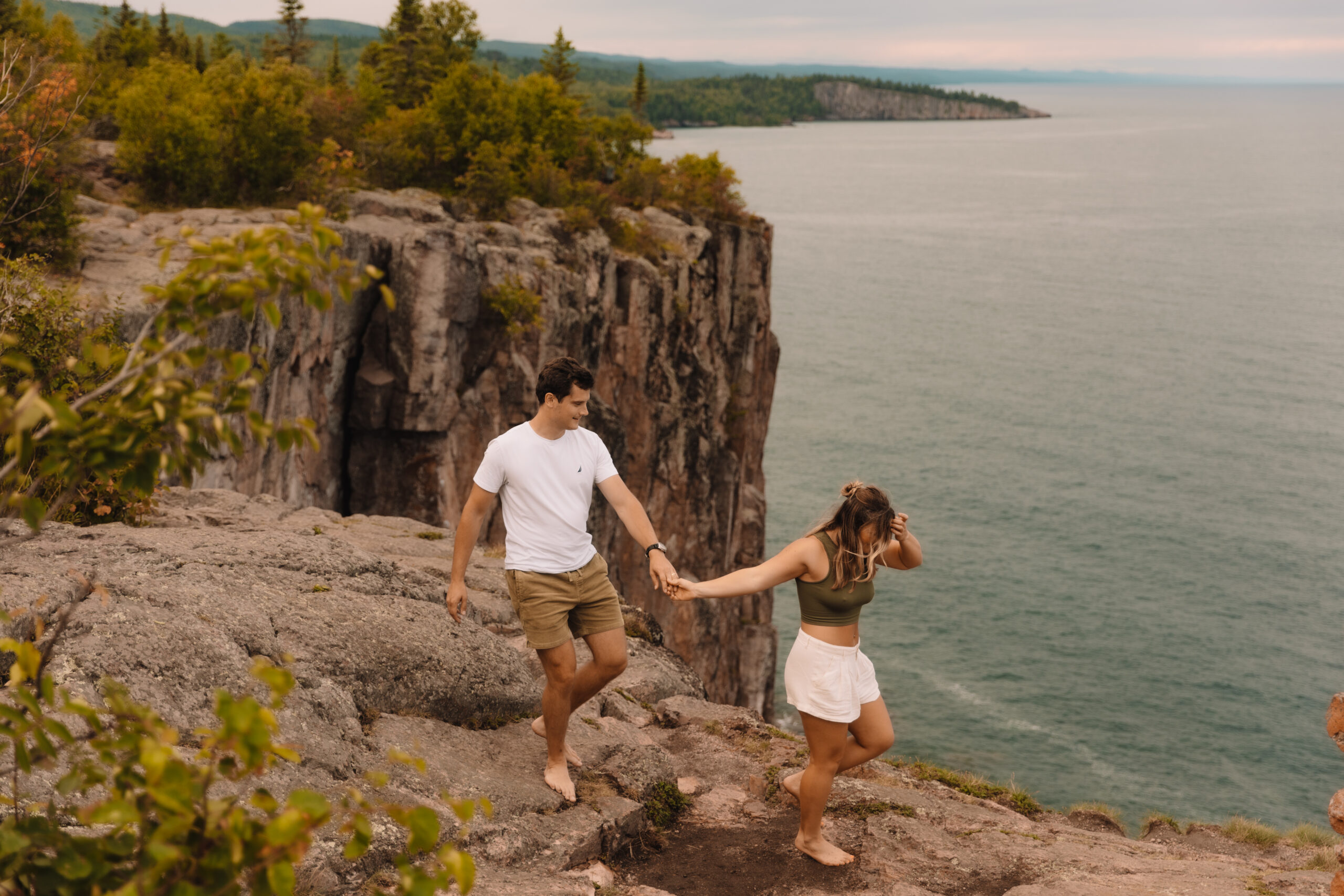 An engagement couple walking along Palisade head in the North Shore of Minnesota
