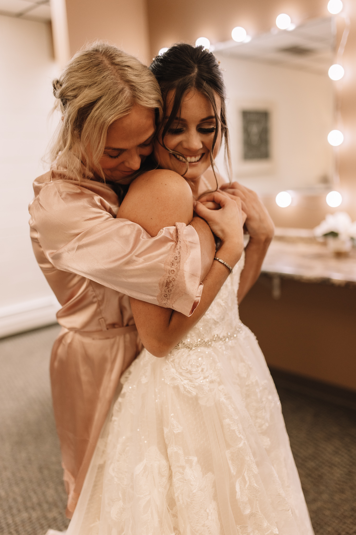 A mother hugging her daughter on her wedding day in the bridal suite