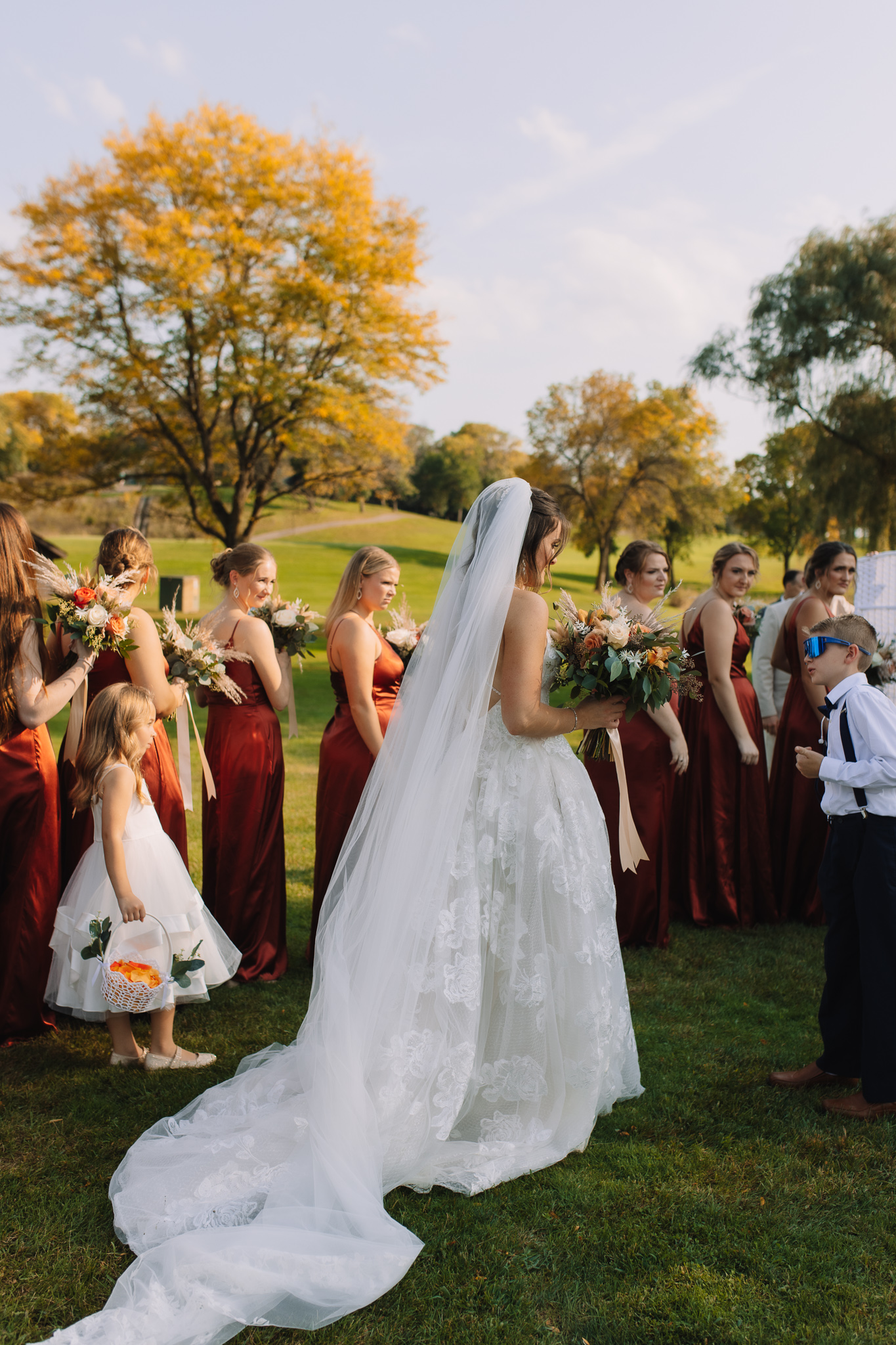 A bride walking down the aisle at her outdoor wedding ceremony in Stillwater, Minnesota