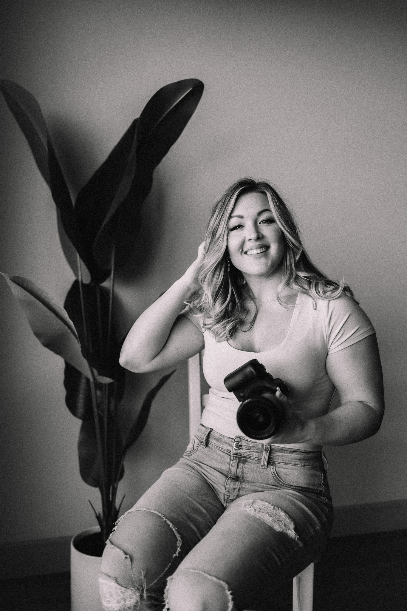 Minnesota Wedding Photographer smiling holding camera