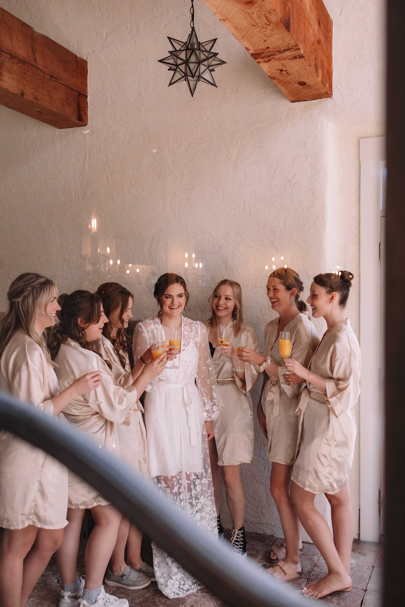 Bride and bridesmaids toasting while getting ready 