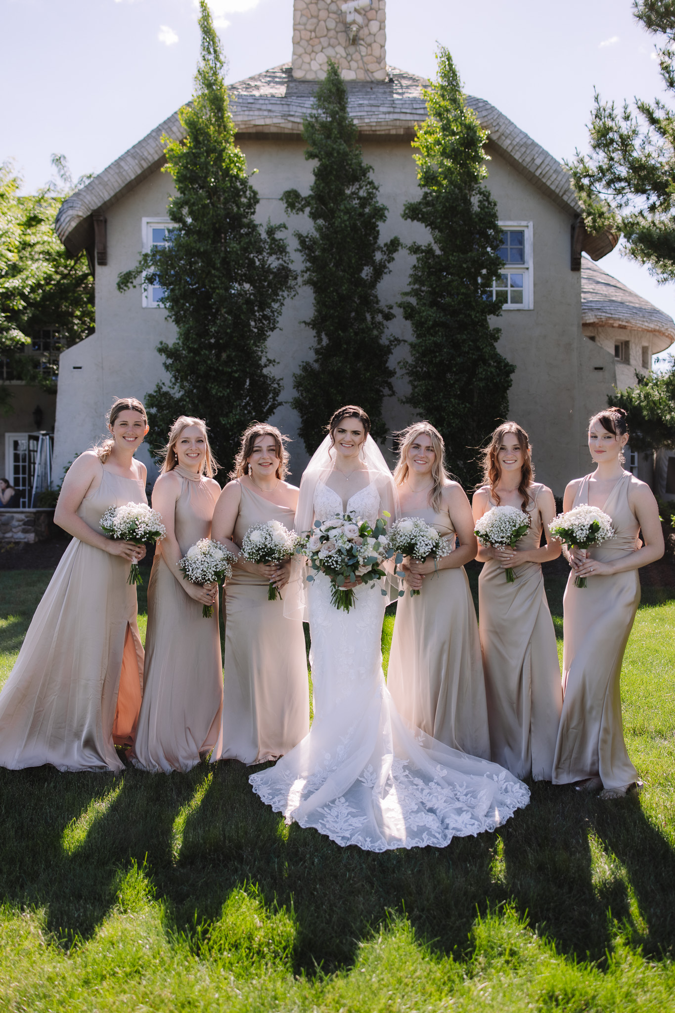 Bride and Bridesmaids posing holding white bouquets at Edward Anne Estate Wedding Venue