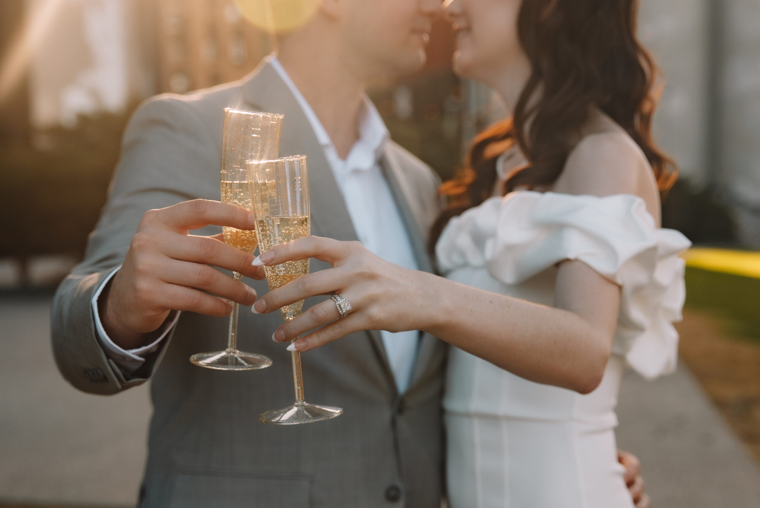 Newly engaged couple toasting champagne glasses