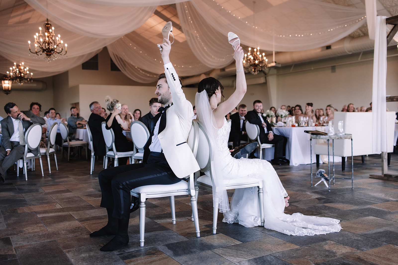 Bride and groom playing a wedding game in the reception space of Edward Anne Estate