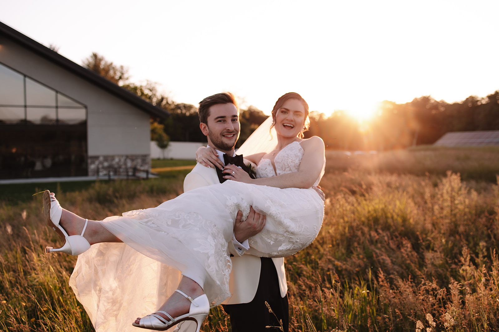 Groom holding bride smiling during sunset at Edward Anne Estate 