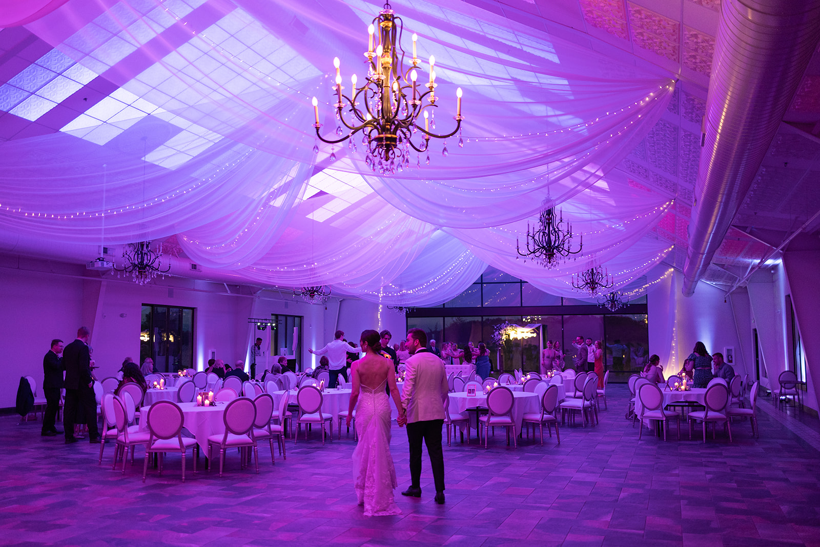 Bride and groom walking into the Edward Anne Estate reception space 