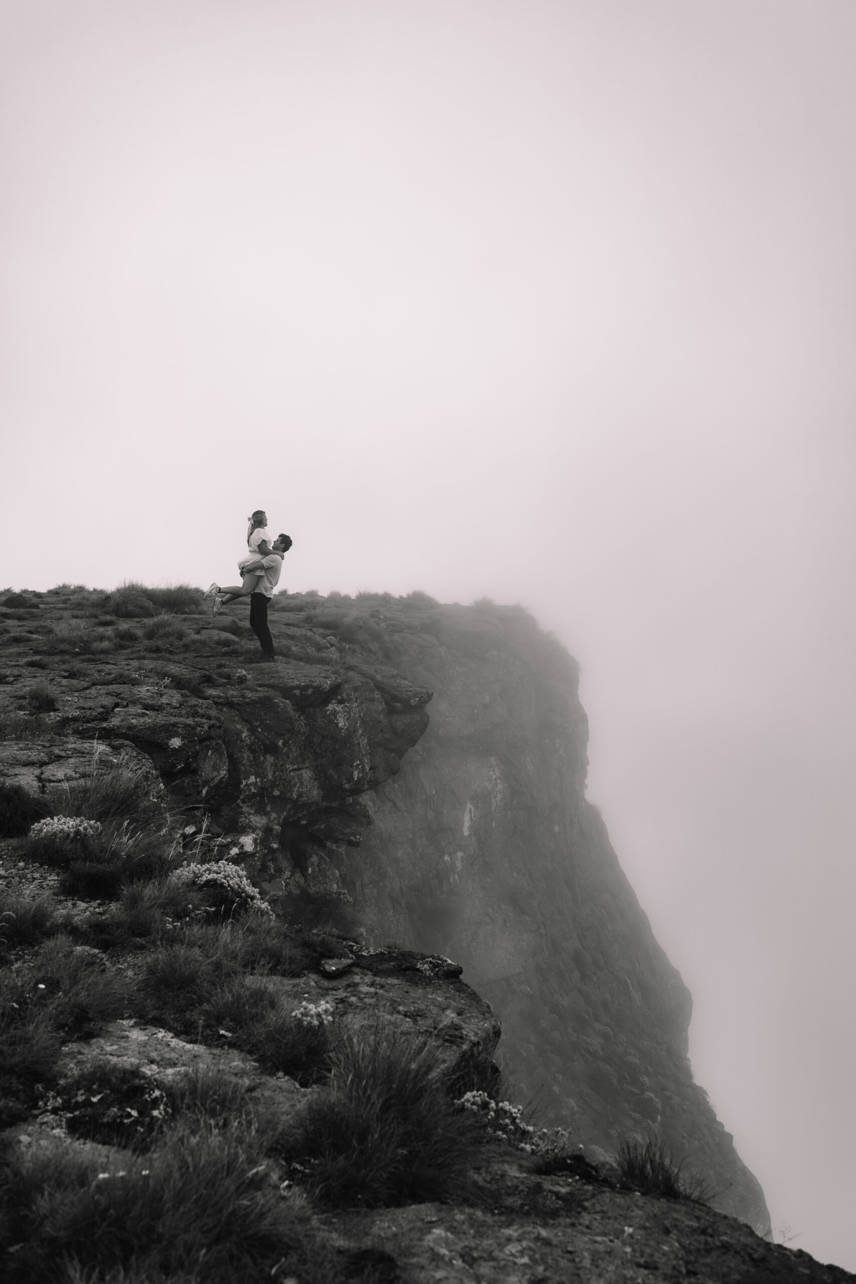 An elopement couple on top of a cliff in the Drakensberg - one of the Top elopement destinations in South Africa