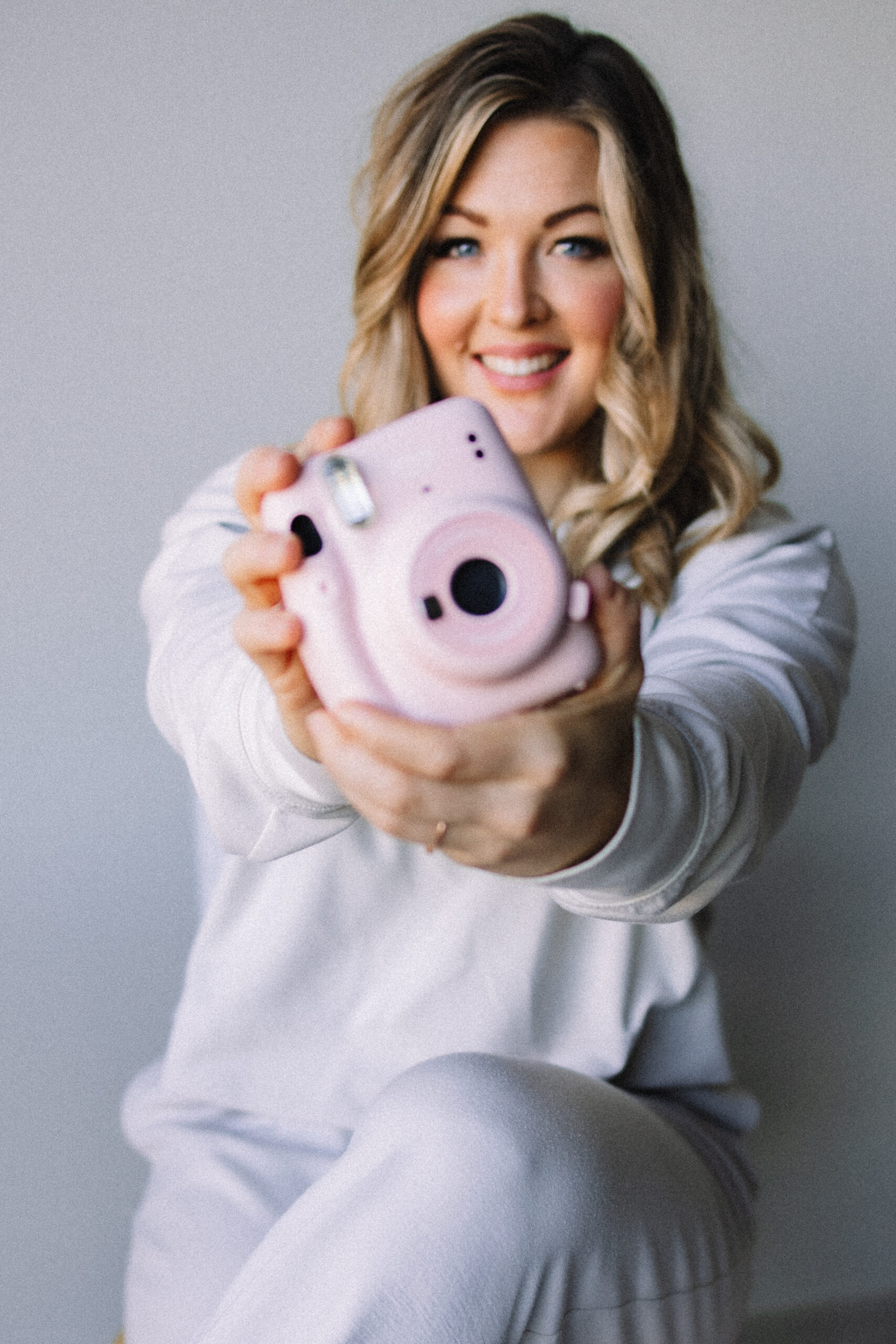 Minnesota Wedding Photographer smiling Polaroid holding camera