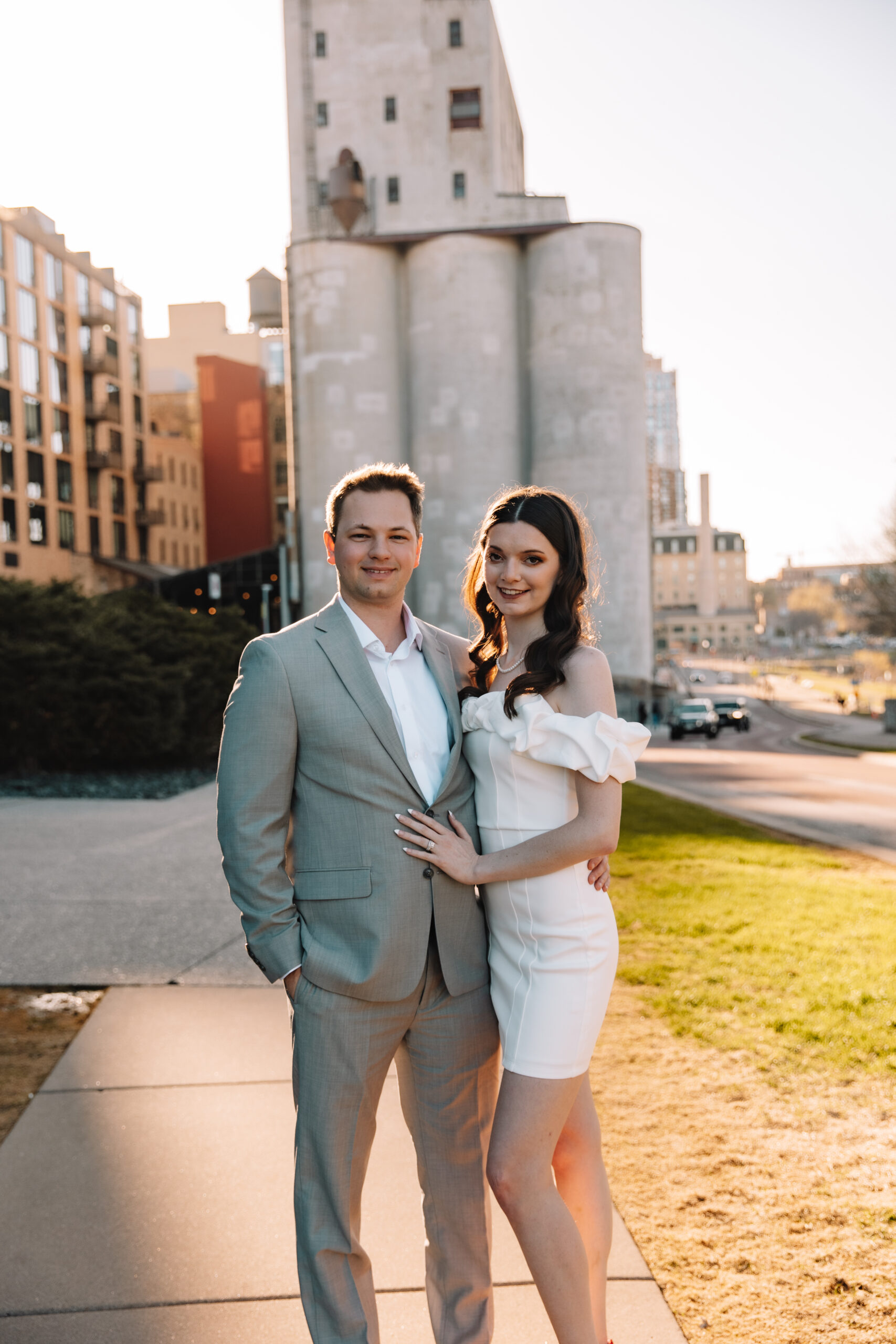 Newly engaged couple smiling posing next to eachother for their engagement photo locations in Minnesota