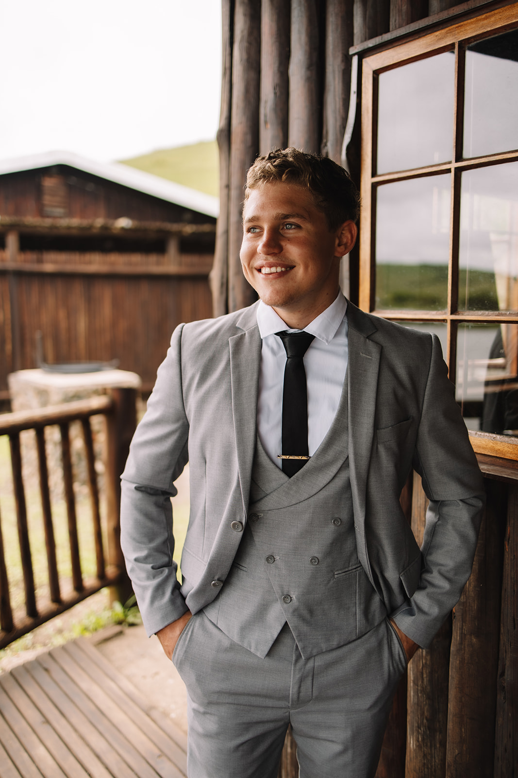 Groom smiling in a grey suite for his destination wedding in South Africa