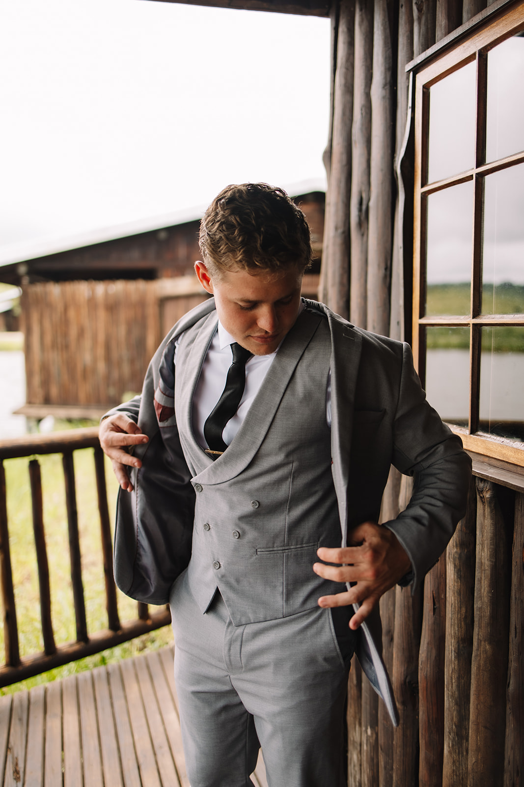 Groom getting ready at a sleeper chalet at Lake Eland for his destination wedding in South Africa