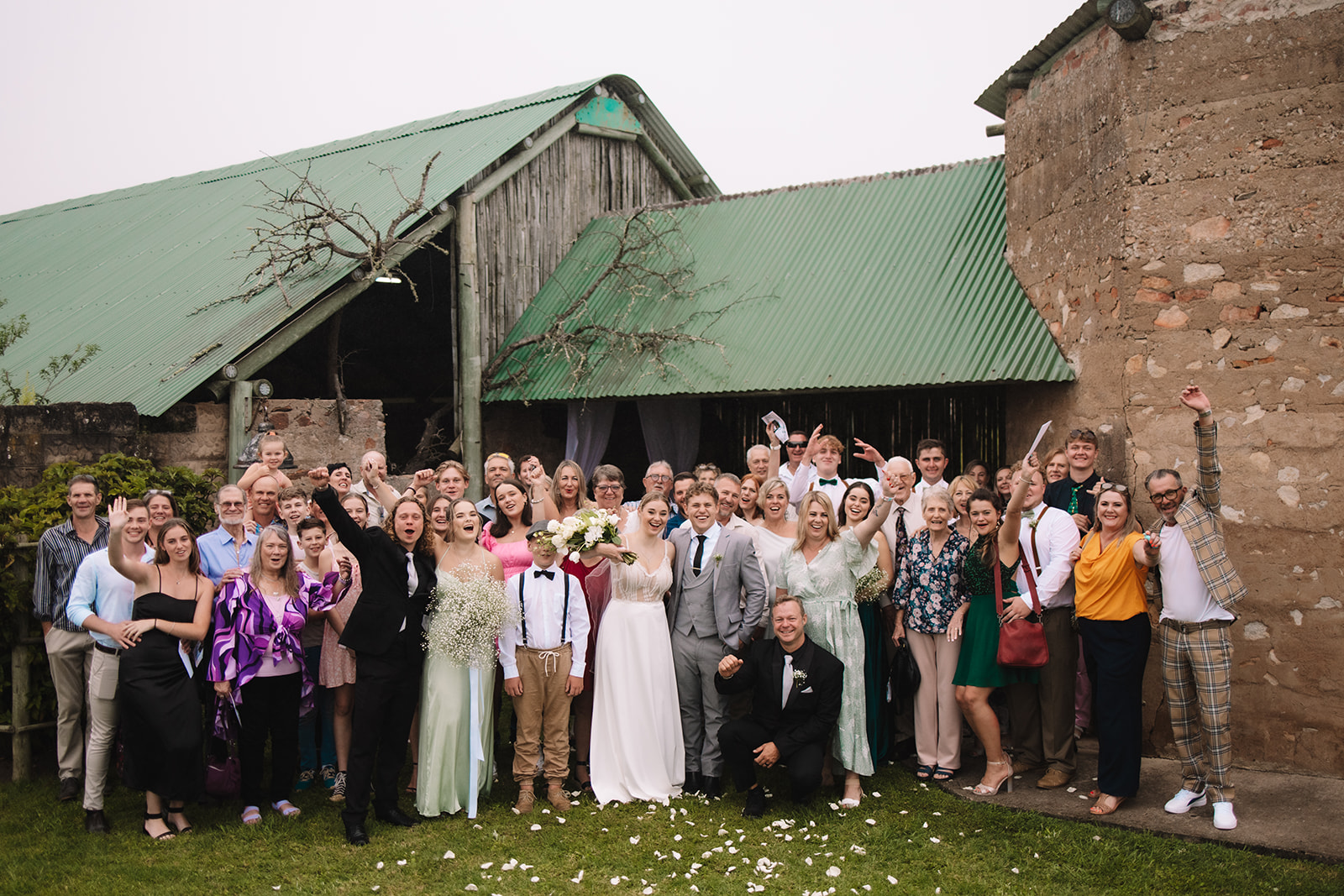 Bride and groom cheering with their family after they exchanged vows