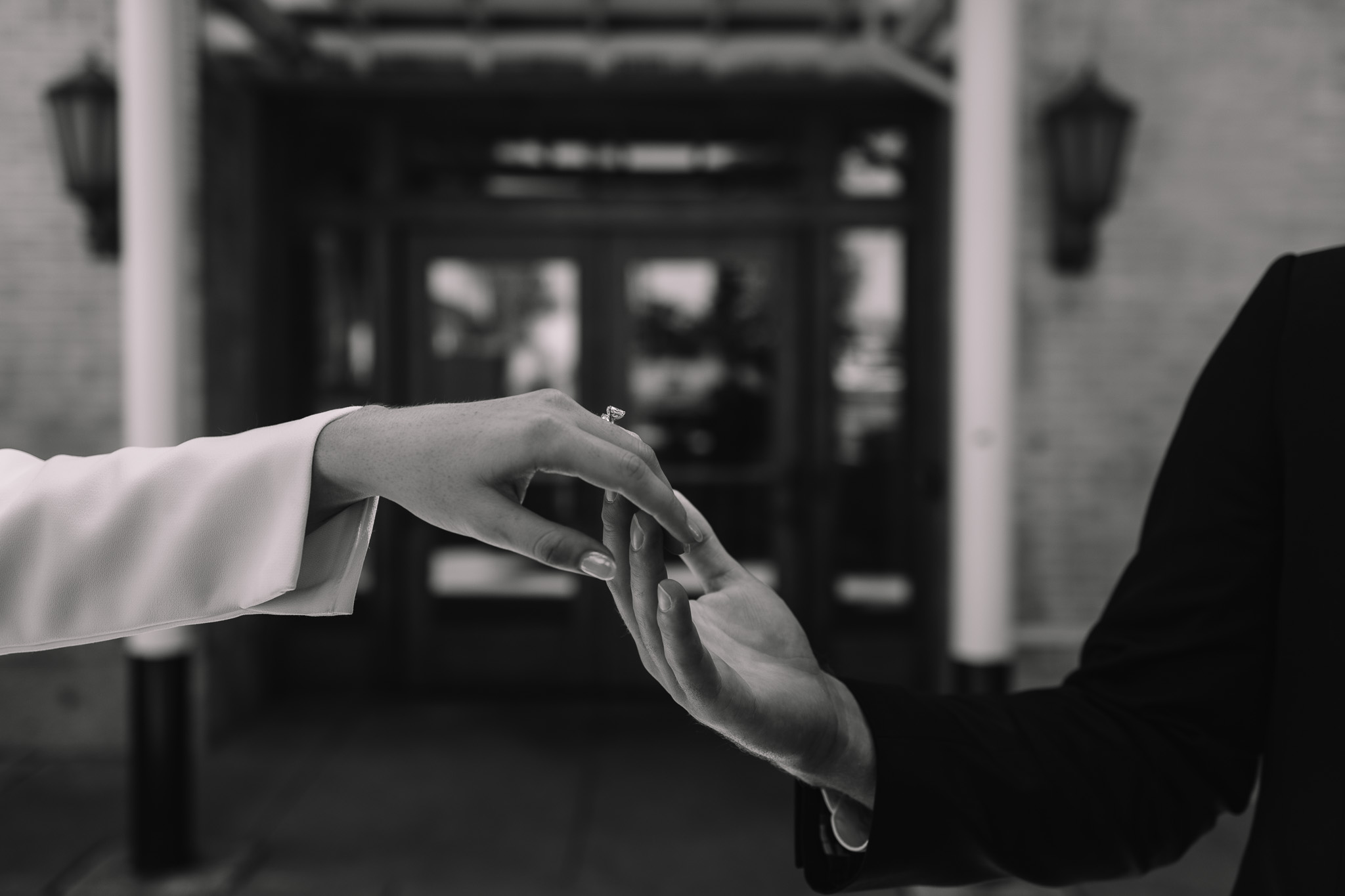 Detail shot of bride and groom hands touching, brushing over each other