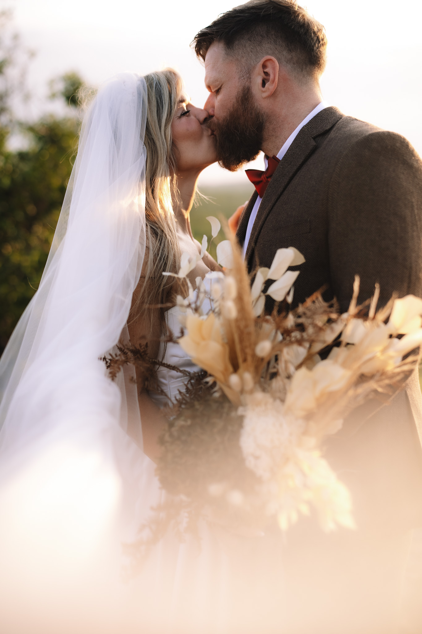 Bride and groom kissing on their safari wedding