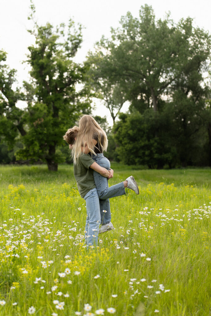 Boy holding his girl during their engagement session at Lake Minnewashta in Chanhassen Minnesota