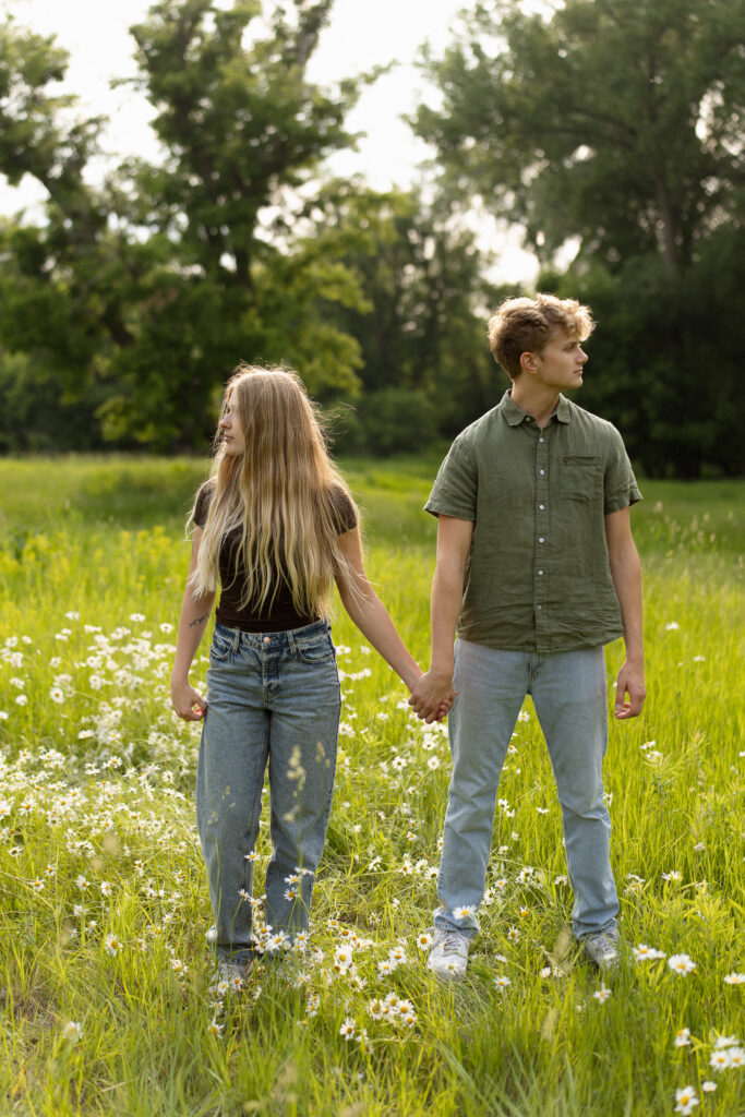 Engagement couple holding hands at Lake Minnewashta Regional Park