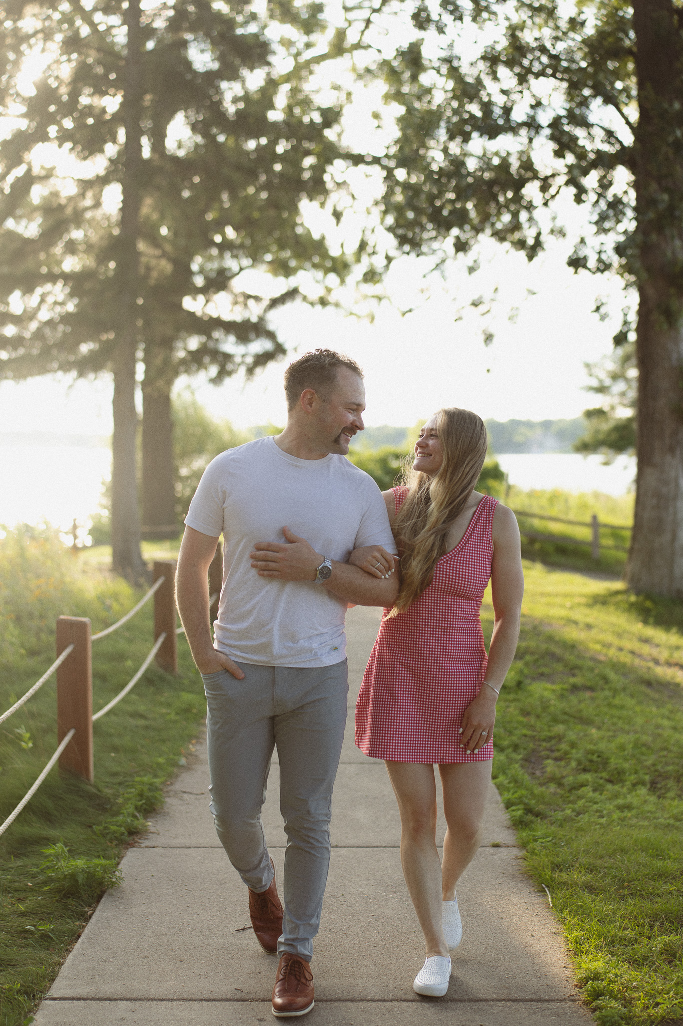 Engagement couple walking towards the engagement photographer during their engagement session in Excelsior