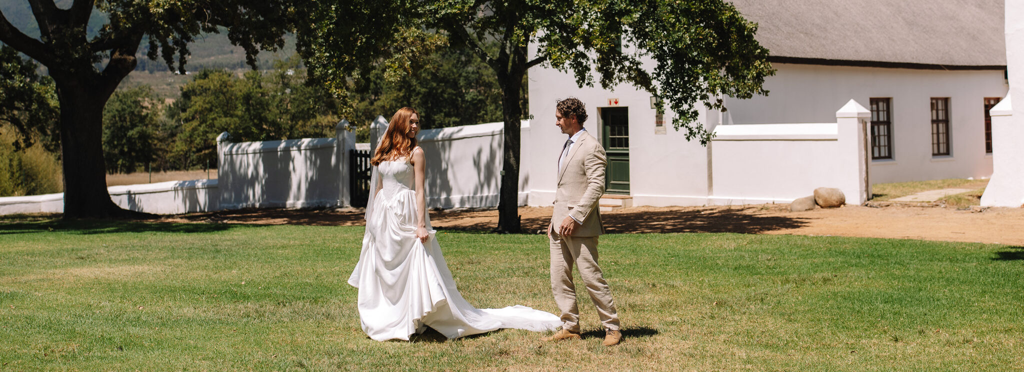 Bride and Groom walking in front of a beautiful wedding venue