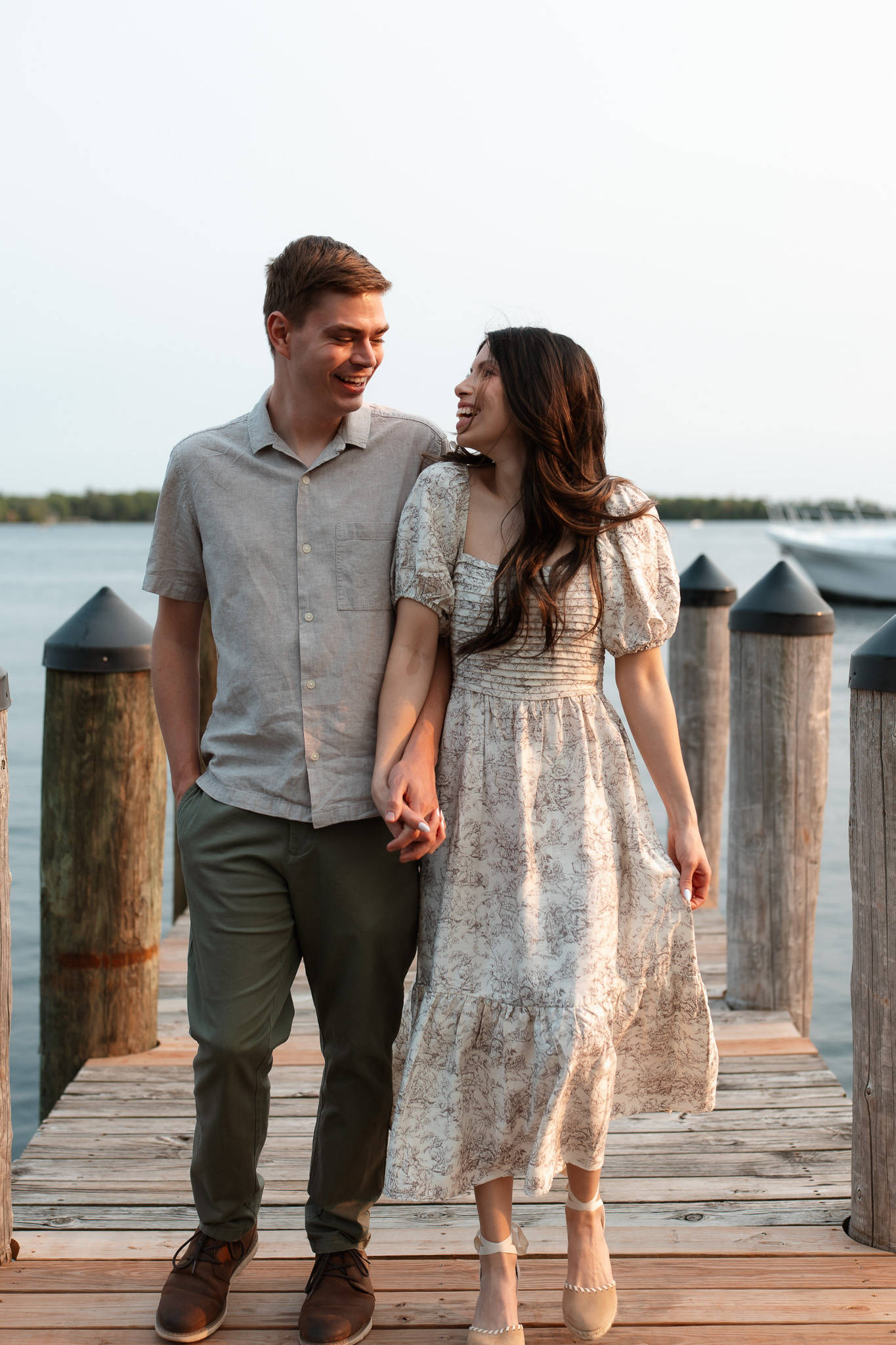 Engagement couple walking on the docks at wayzata beach