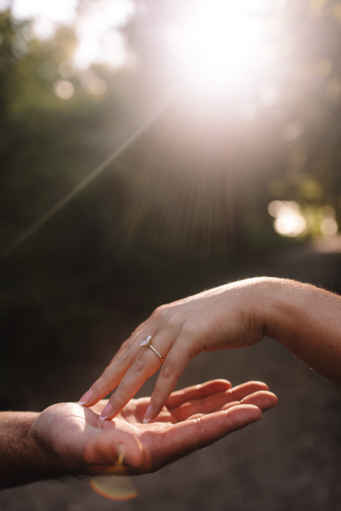 Close up hand photo of an engaged couple