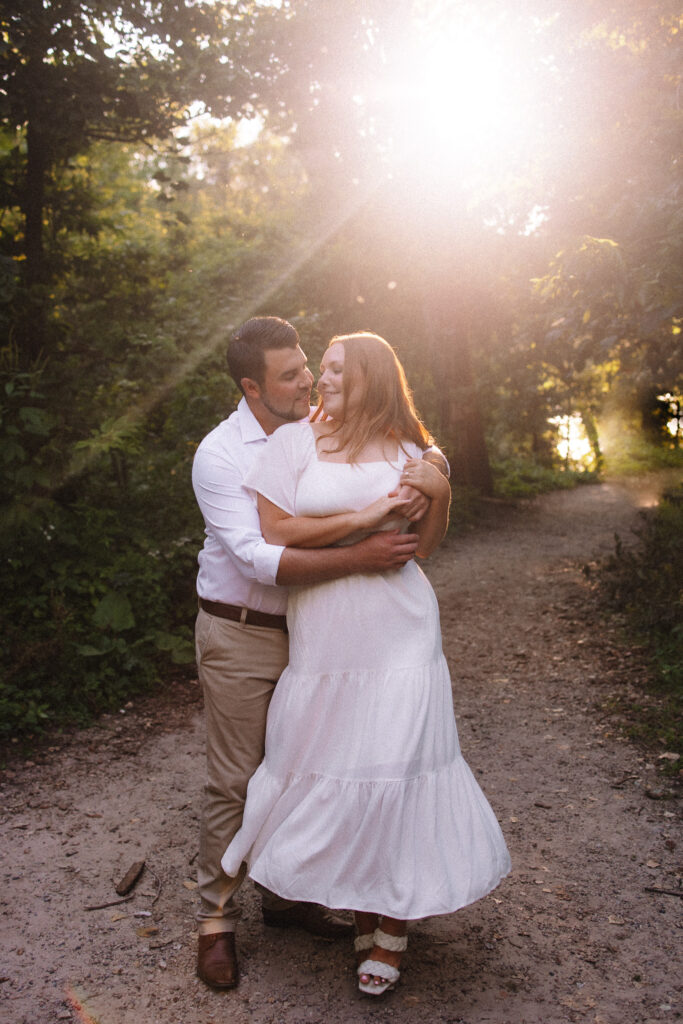 Guy spinning his girl around during their engagement session at the Noerenberg Gardens in Orono- one of the best engagement photo locations in Minneapolis' west suburbs