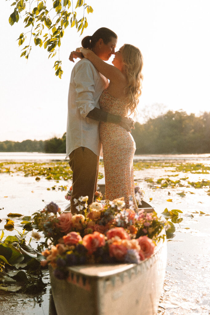 Guy and girl facing and holding each other during their engagement session at Excelsior beach - One of the best engagement locations in Minneapolis' West suburbs