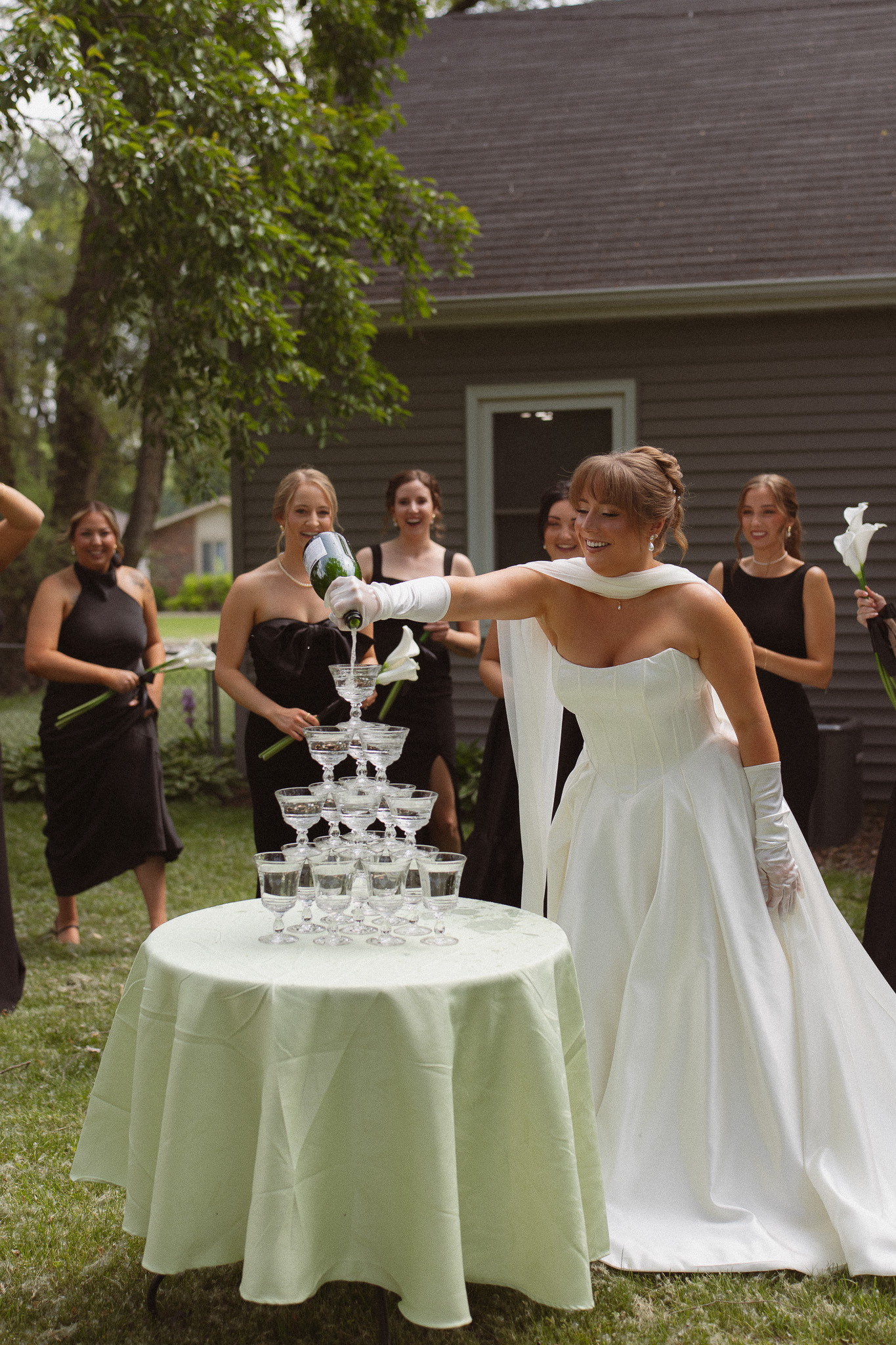 Bride doing a champagne tower with her bridesmaids