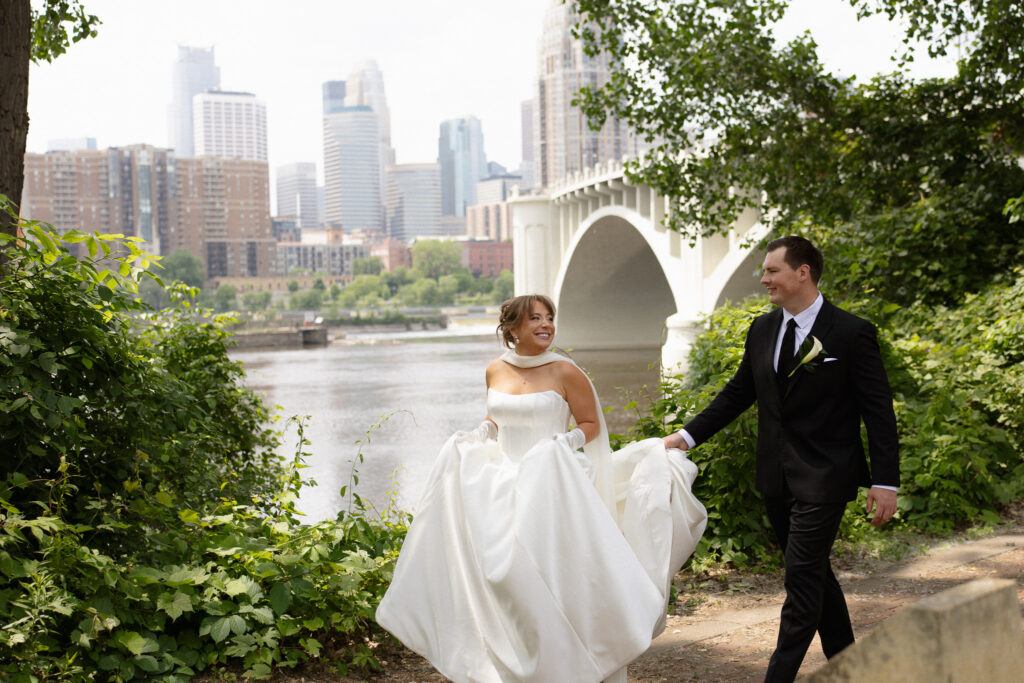 Bride and groom walking through Nicollet Island near The View, Minneapolis Event Centers