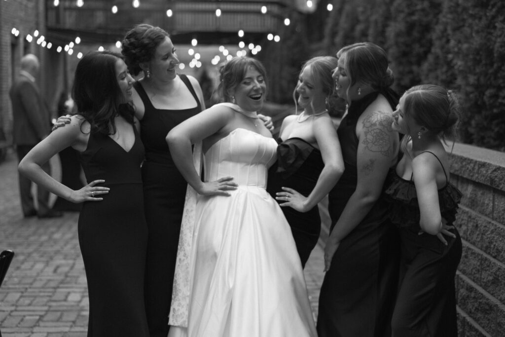 Bridal party having fun under twinkle lights at The View Minneapolis Event Center in St Anthony Main