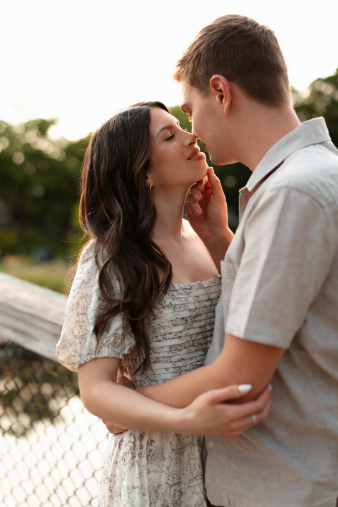 Engagement couple holding each other and looking into each other's eyes for their Wayzata engagement photos