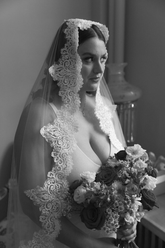 Black and white photo of a bride in her beautiful timeless veil